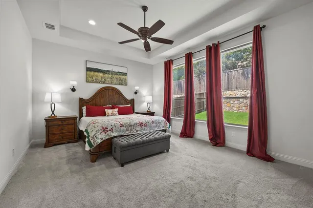 a bedroom with a large bed and a chandelier