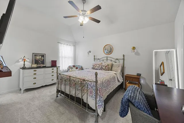 a bedroom with bed and a chandelier