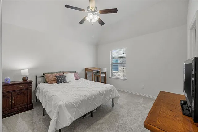 a bedroom with a bed and a tv