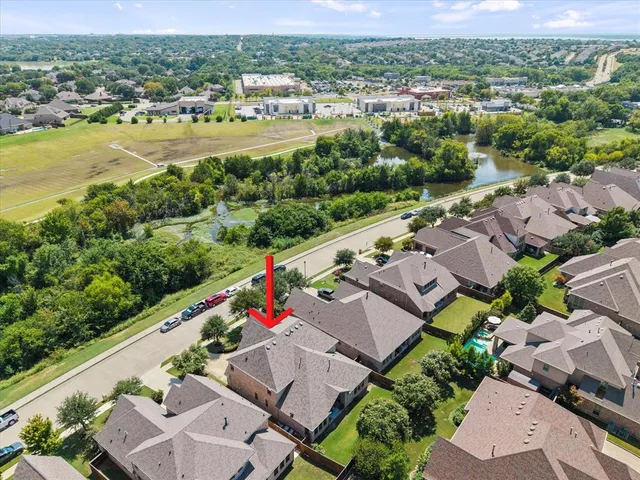 an aerial view of residential houses with outdoor space and river