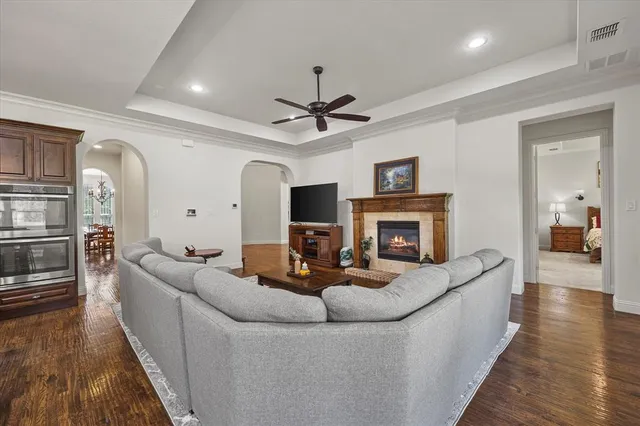 a living room with furniture a fireplace and a wooden floor
