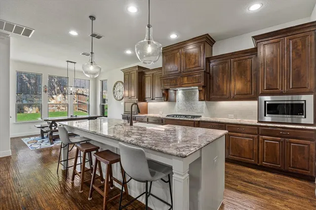 a kitchen with center island table and chairs in it