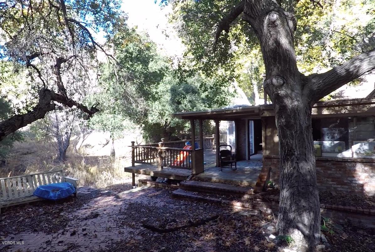 18452 Little Tujunga Canyon Road Canyon Country, CA 91387 - Photo 11 of 61 a front view of a house with a yard swing table and chairs