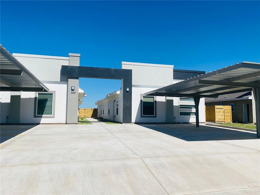 View of property exterior featuring stucco siding and covered parking