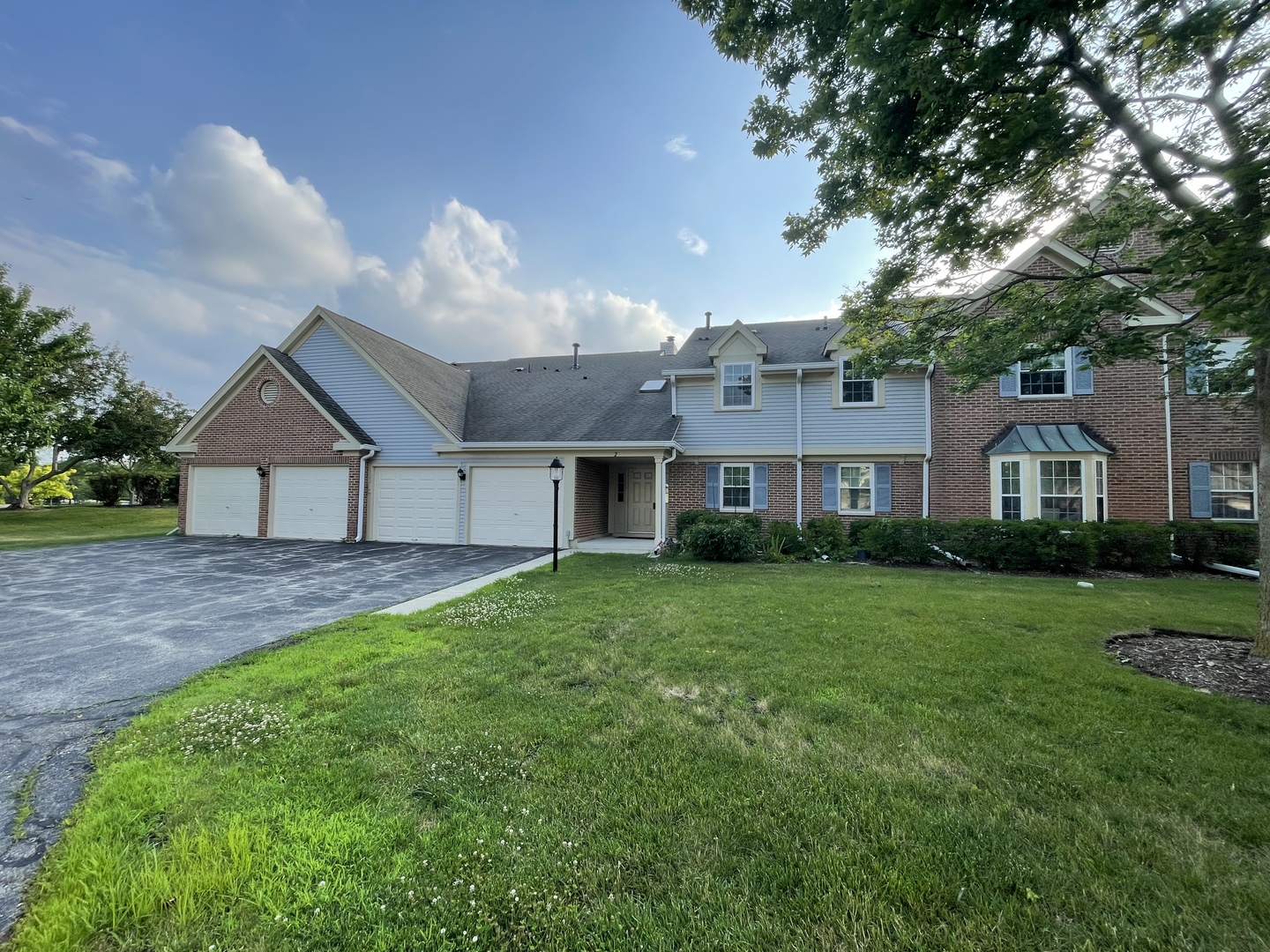 2 Aberdeen Court, Unit W1 Schaumburg, IL 60107 - Photo 1 of 31 a front view of a house with a yard and garage