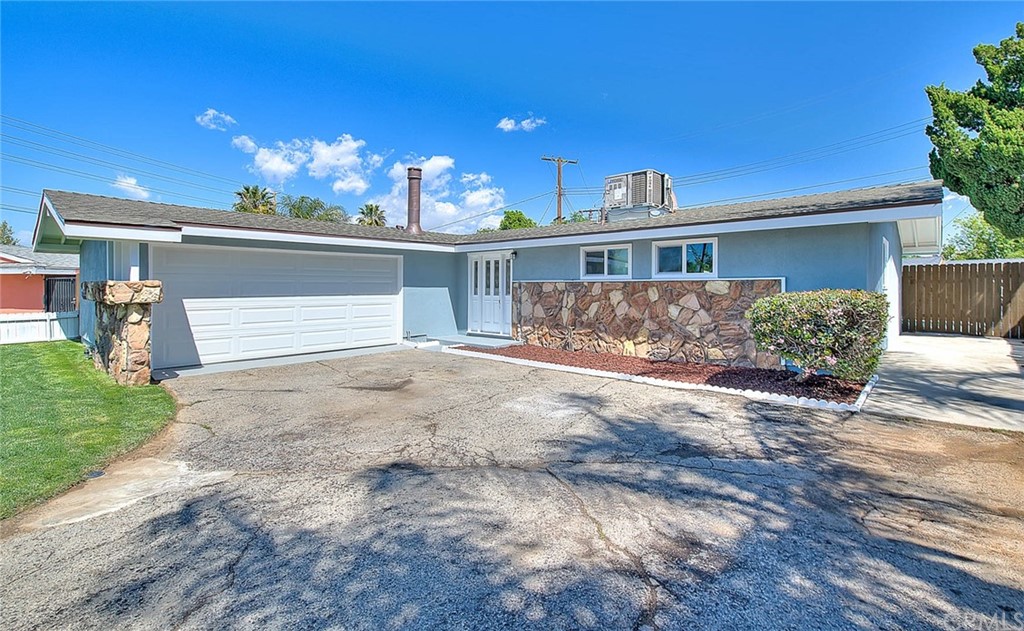 8868 Amber Street Riverside, CA 92503 - Photo 1 of 1 a view of a house with a yard and potted plants