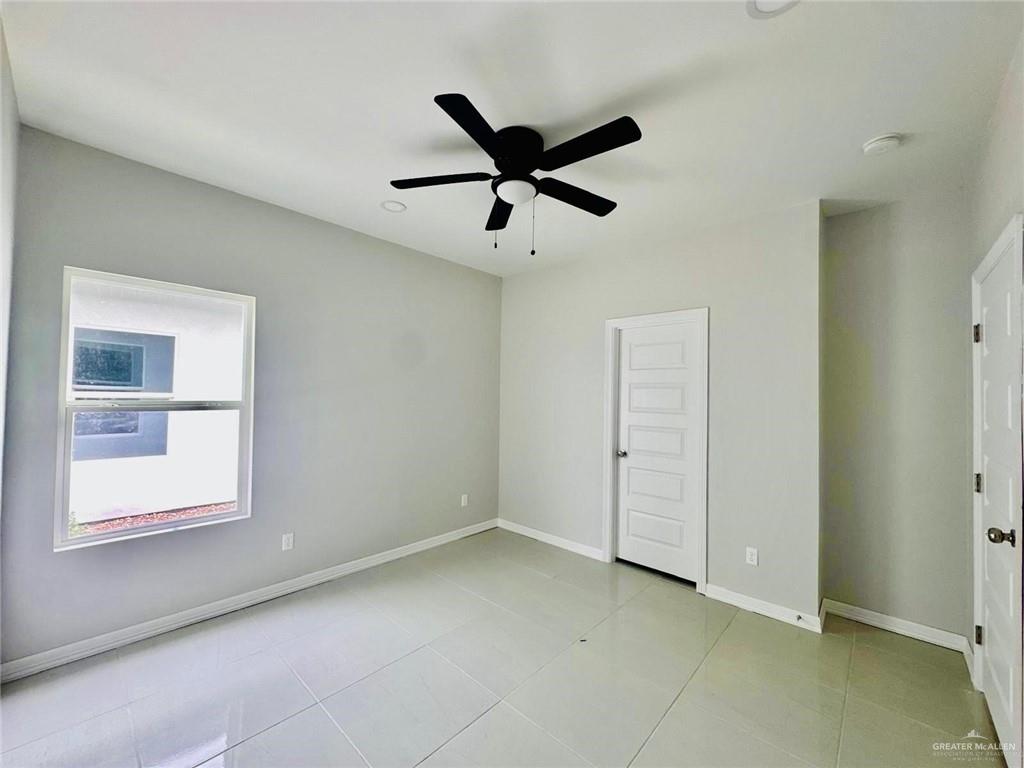 4225 Heron Avenue McAllen, TX 78504 - Photo 16 of 22 a view of a livingroom with a ceiling fan & window