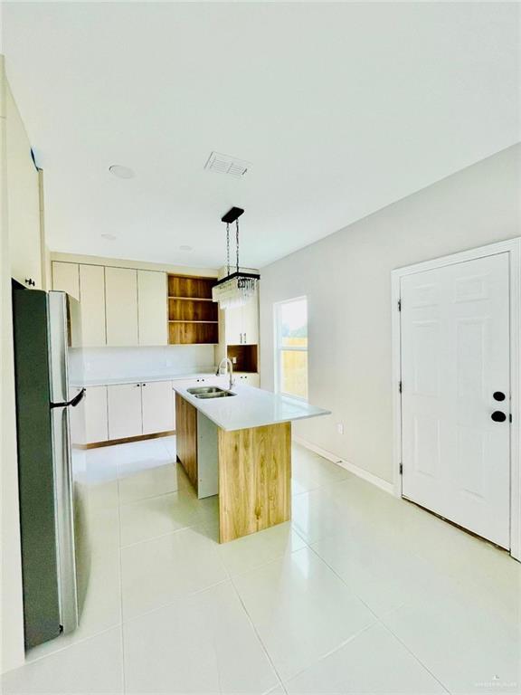 4225 Heron Avenue McAllen, TX 78504 - Photo 18 of 22 a large kitchen with a refrigerator a stove a sink a microwave and cabinets