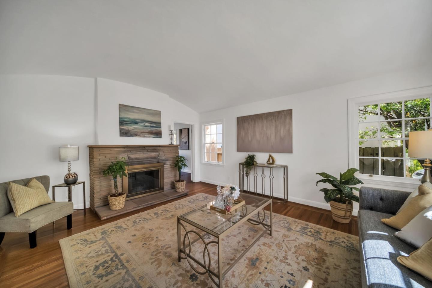 132 Dwight Road Burlingame, CA 94010 - Photo 12 of 69 a living room with furniture a flat screen tv and a fireplace