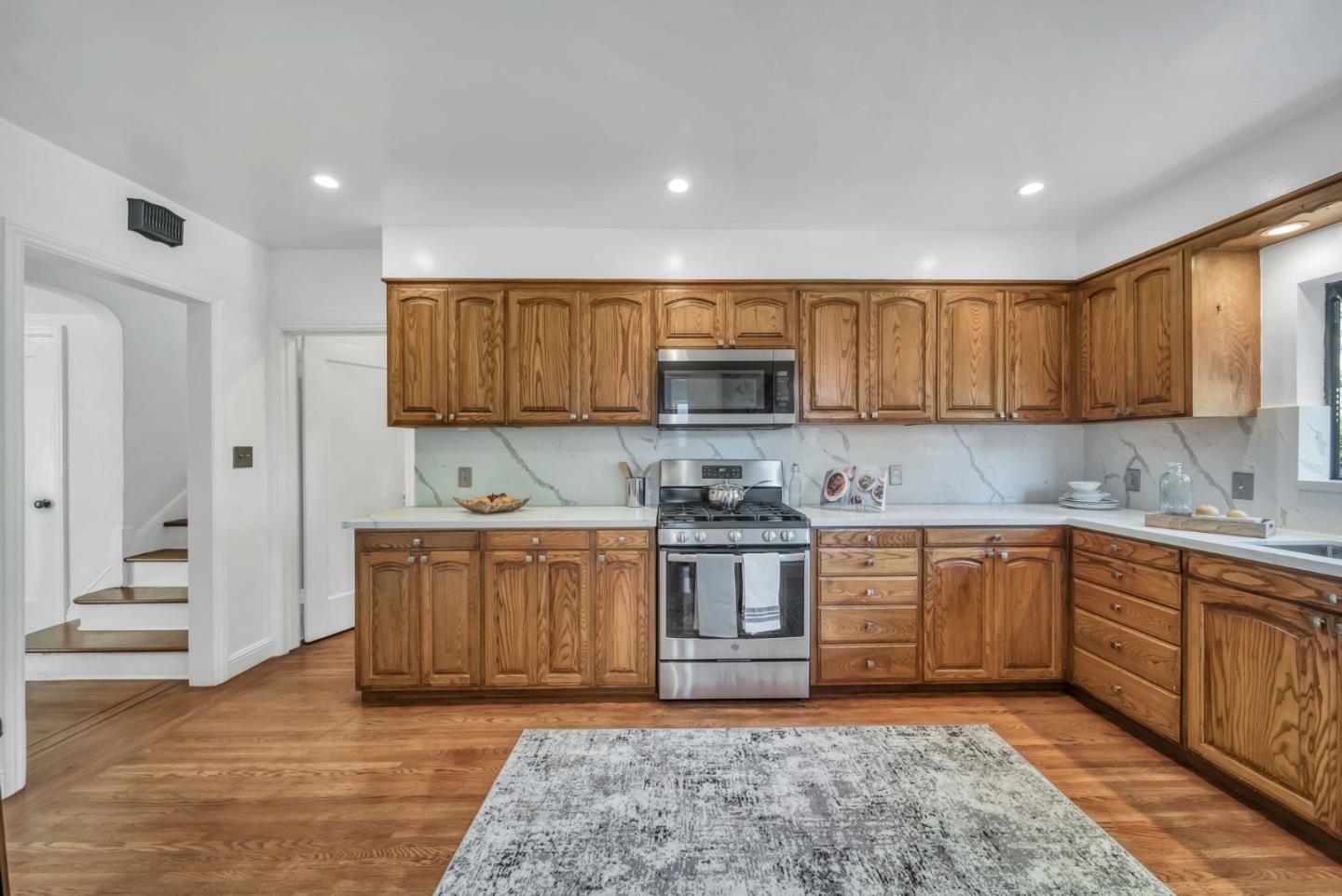 132 Dwight Road Burlingame, CA 94010 - Photo 16 of 69 a kitchen with stainless steel appliances granite countertop a sink and cabinets