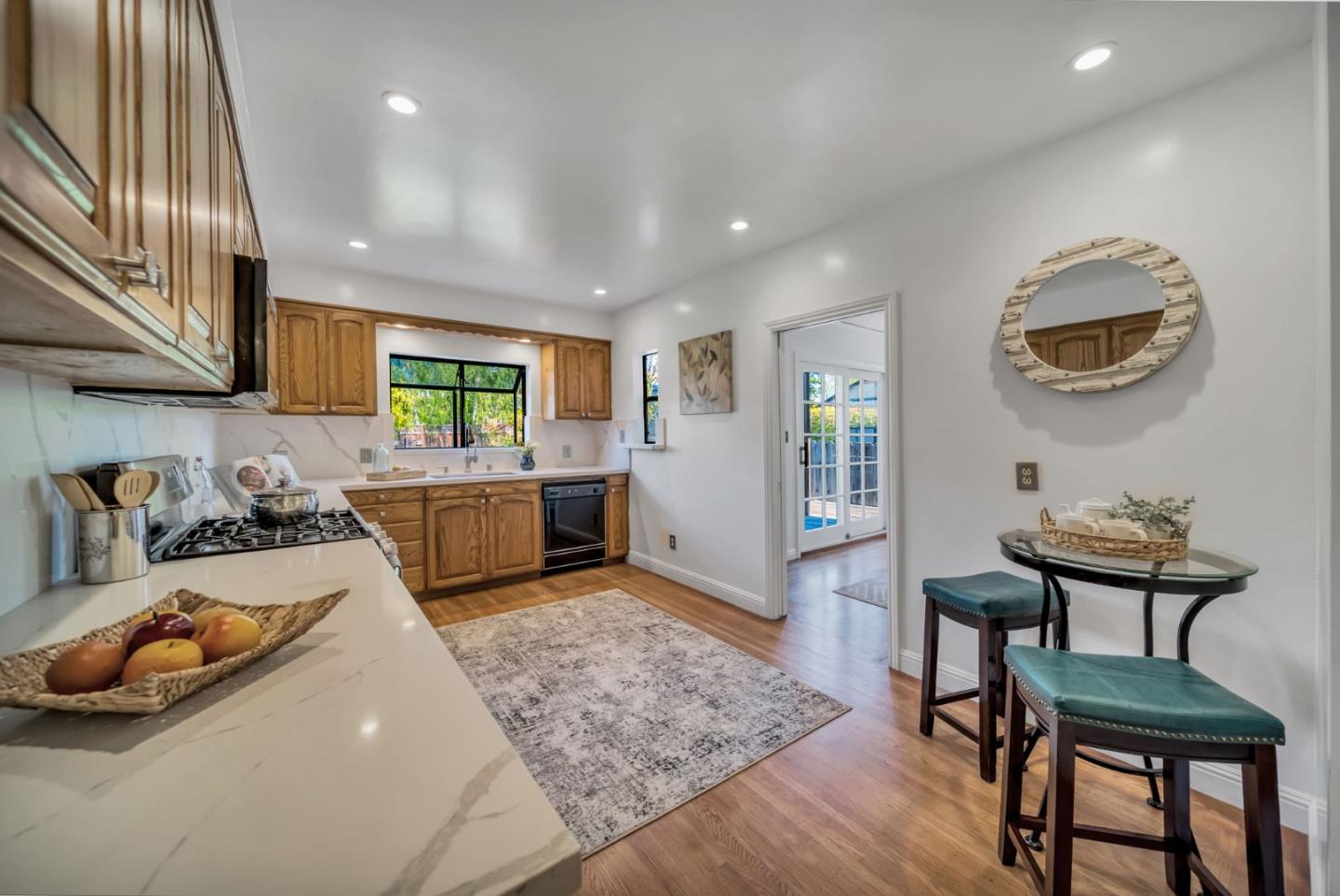 132 Dwight Road Burlingame, CA 94010 - Photo 20 of 69 a kitchen with sink refrigerator dining table and chairs