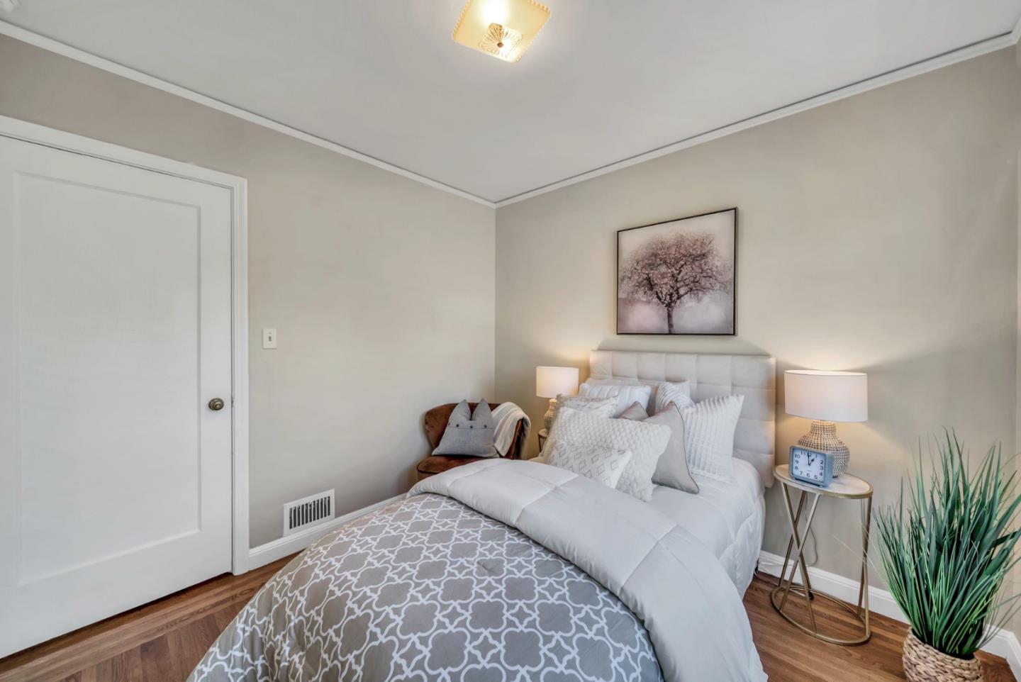 132 Dwight Road Burlingame, CA 94010 - Photo 25 of 69 a bedroom with a bed and a painting on the wall