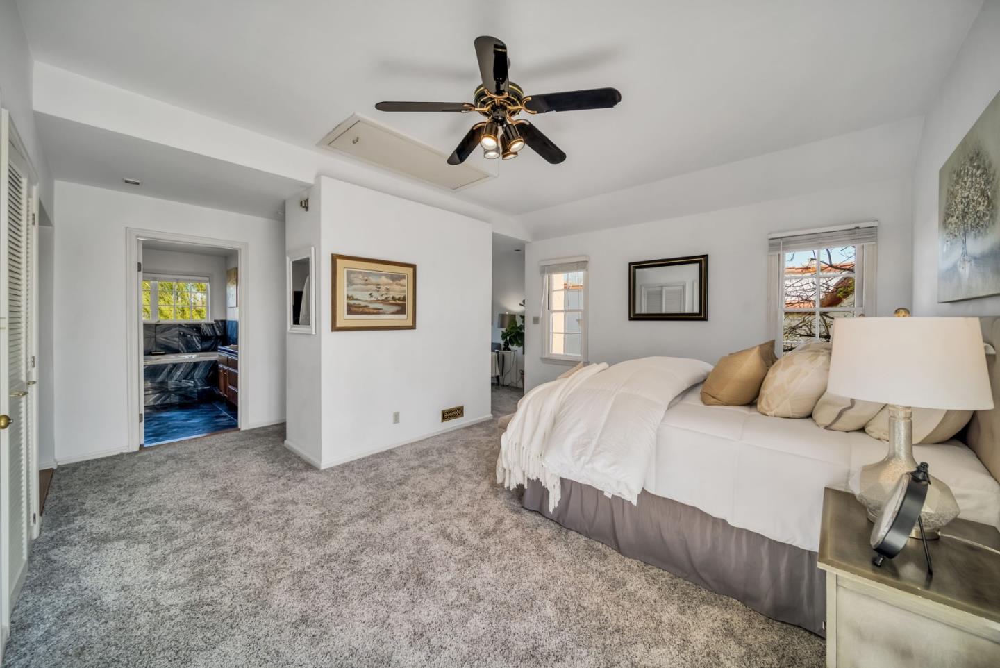 132 Dwight Road Burlingame, CA 94010 - Photo 30 of 69 a spacious bedroom with a bed and a chandelier
