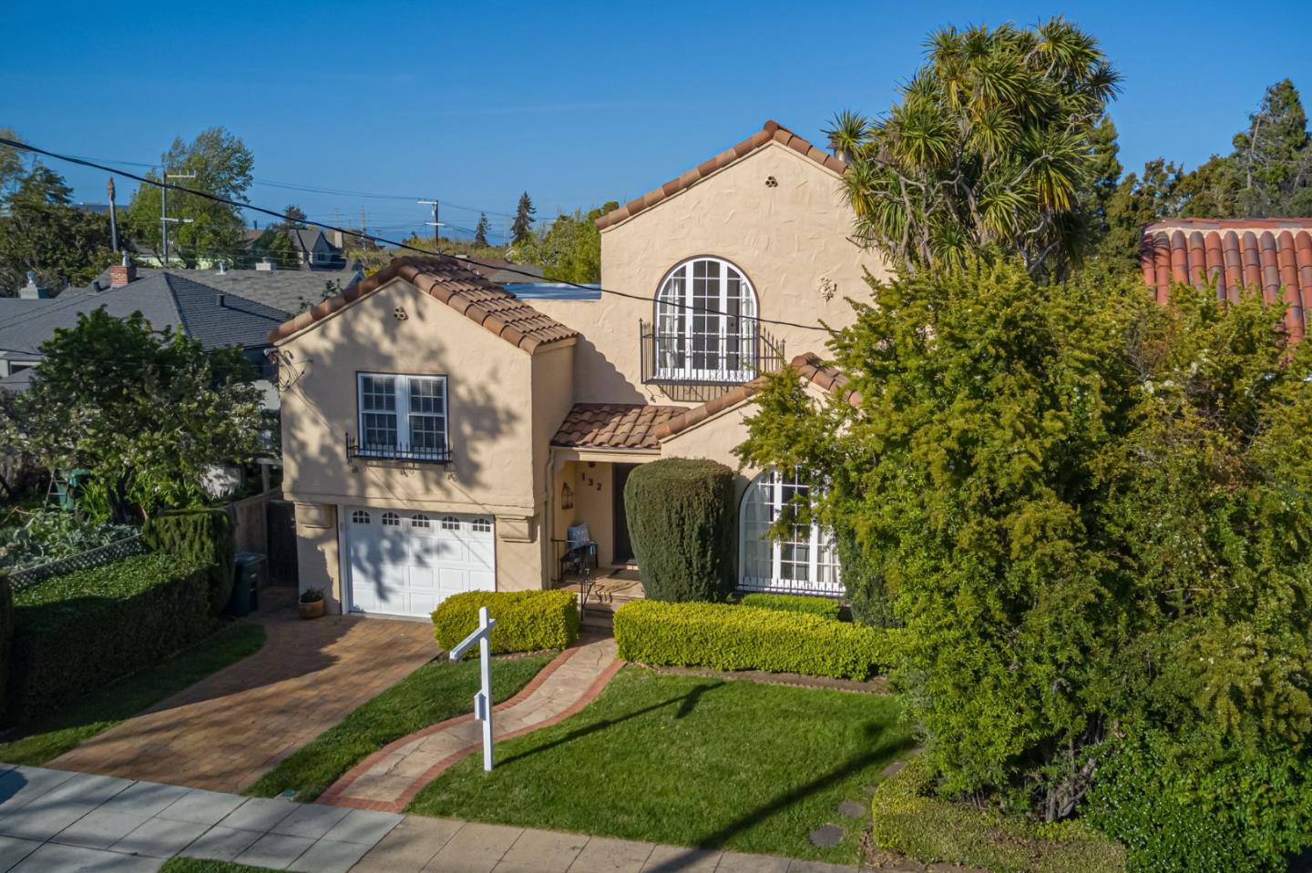 132 Dwight Road Burlingame, CA 94010 - Photo 4 of 69 a view of a brick house with a yard and plants