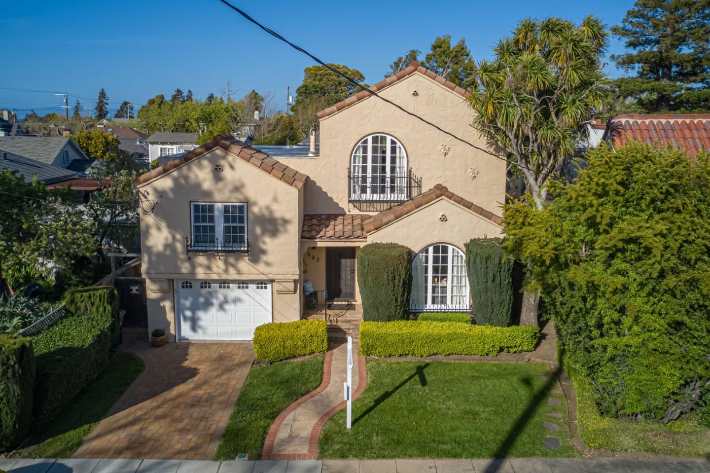 132 Dwight Road Burlingame, CA 94010 - Photo 5 of 69 a view of a white house with a big yard and large tree
