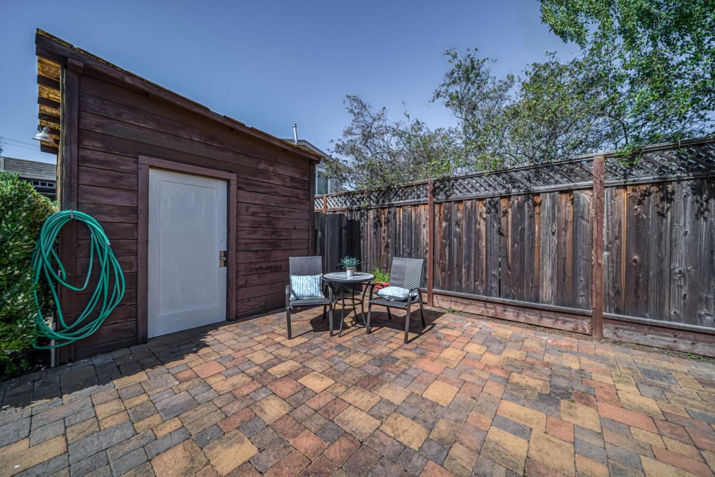 132 Dwight Road Burlingame, CA 94010 - Photo 55 of 69 a backyard of a house with table and chairs