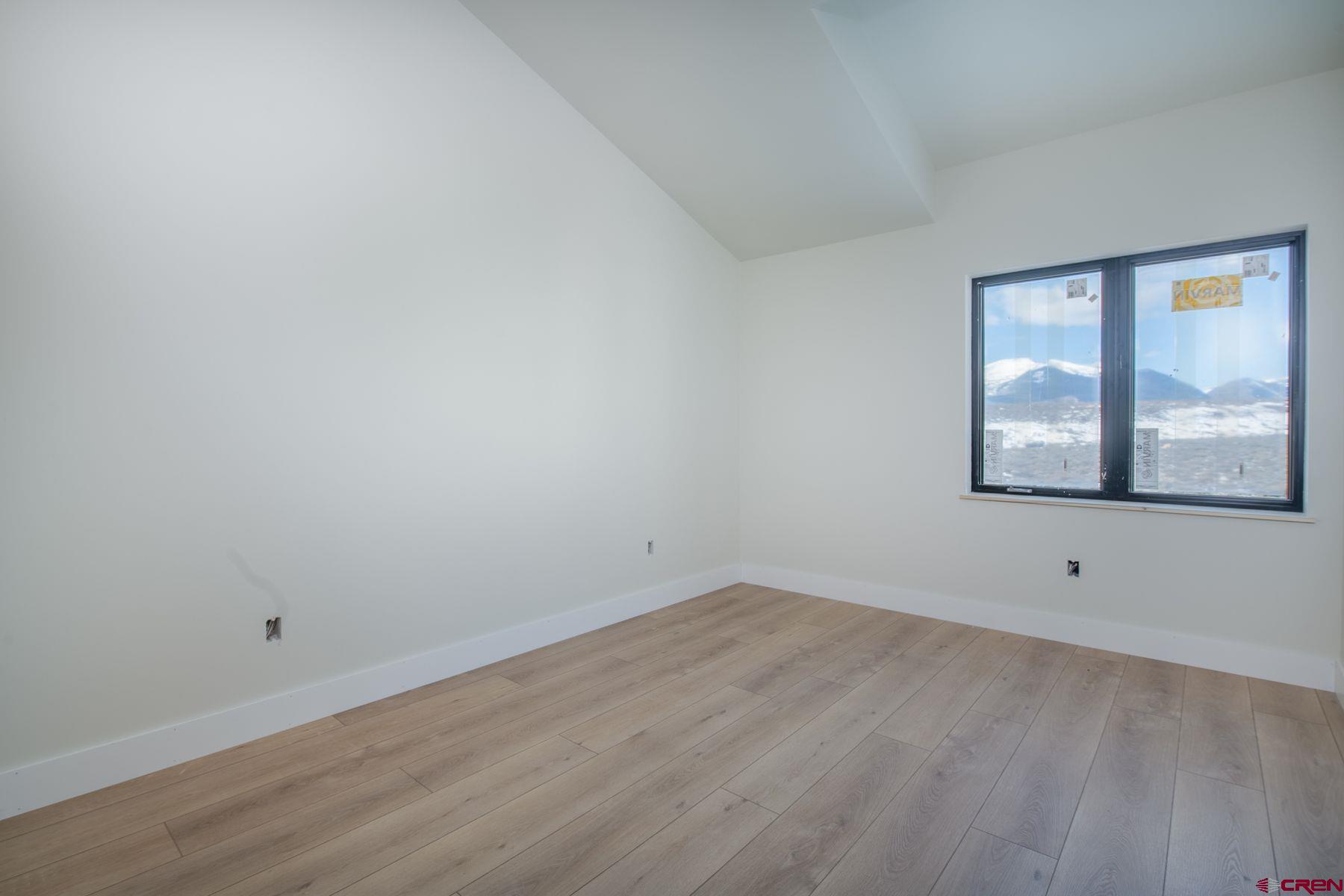 40 Elk Valley Road Crested Butte, CO 81224 - Photo 11 of 25 a view of an empty room with wooden floor and a window