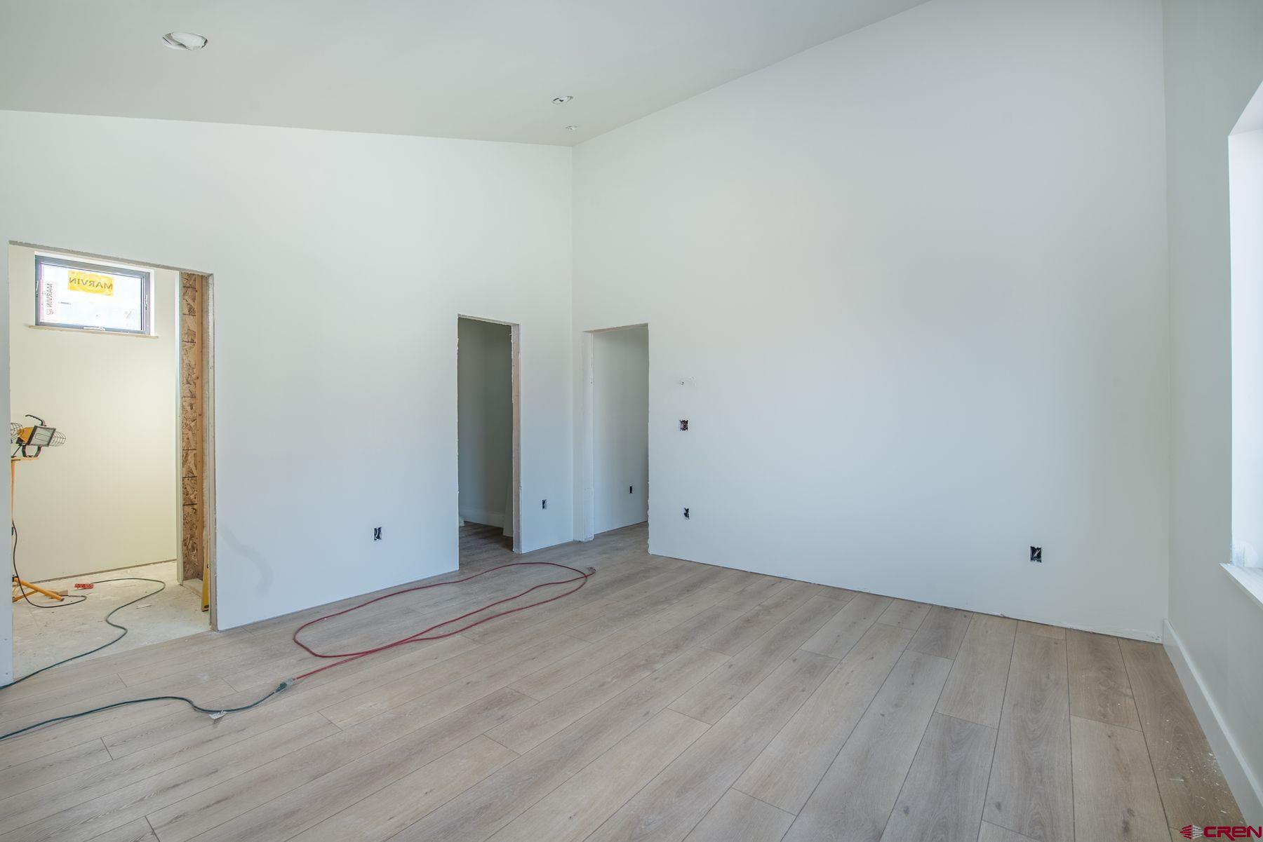 40 Elk Valley Road Crested Butte, CO 81224 - Photo 9 of 25 an empty room with wooden floor and windows
