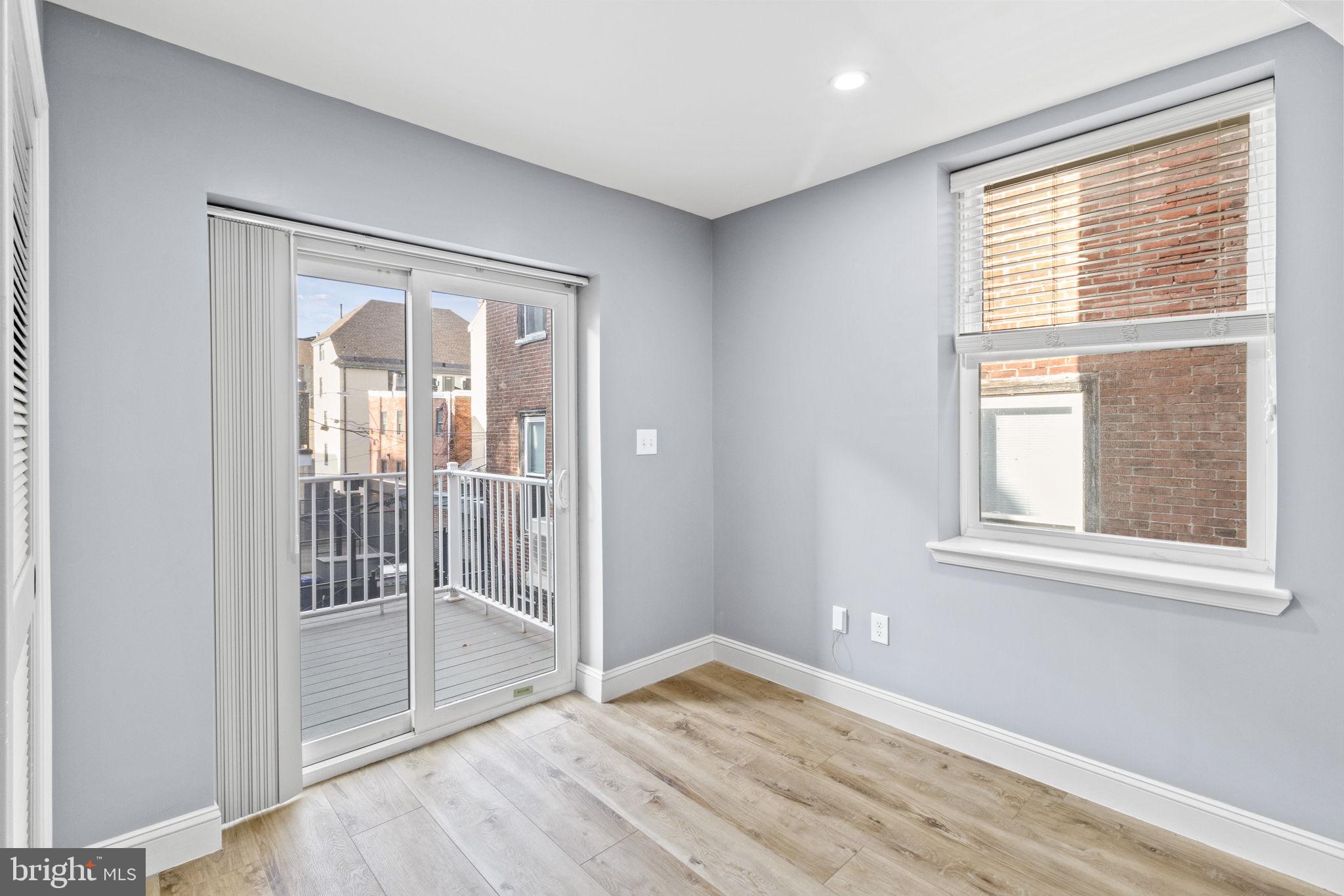 418 South 15th Street, Unit 2R Philadelphia, PA 19146 - Photo 14 of 26 a view of an empty room with wooden floor and a window
