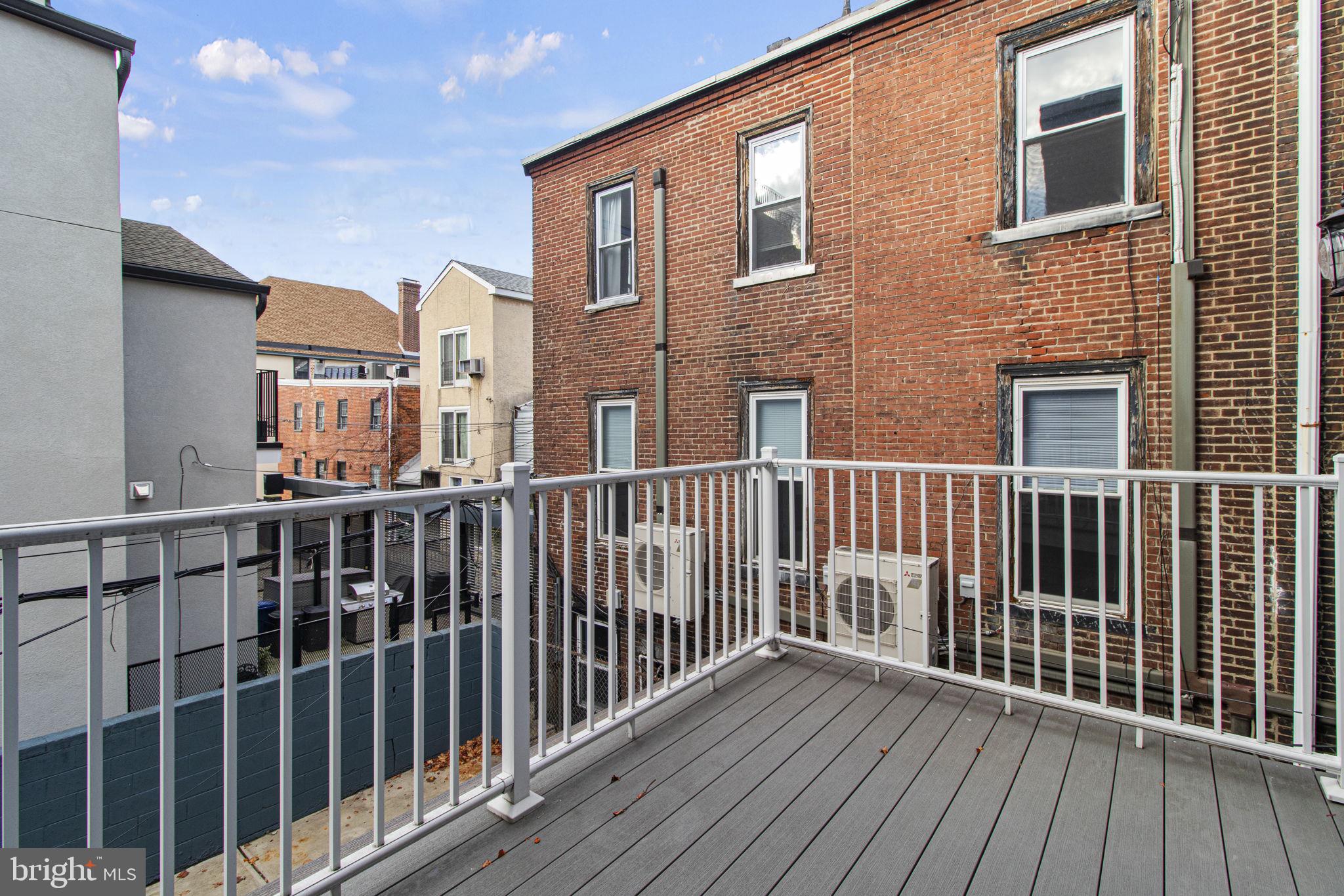 418 South 15th Street, Unit 2R Philadelphia, PA 19146 - Photo 15 of 26 a view of a brick building from a roof deck