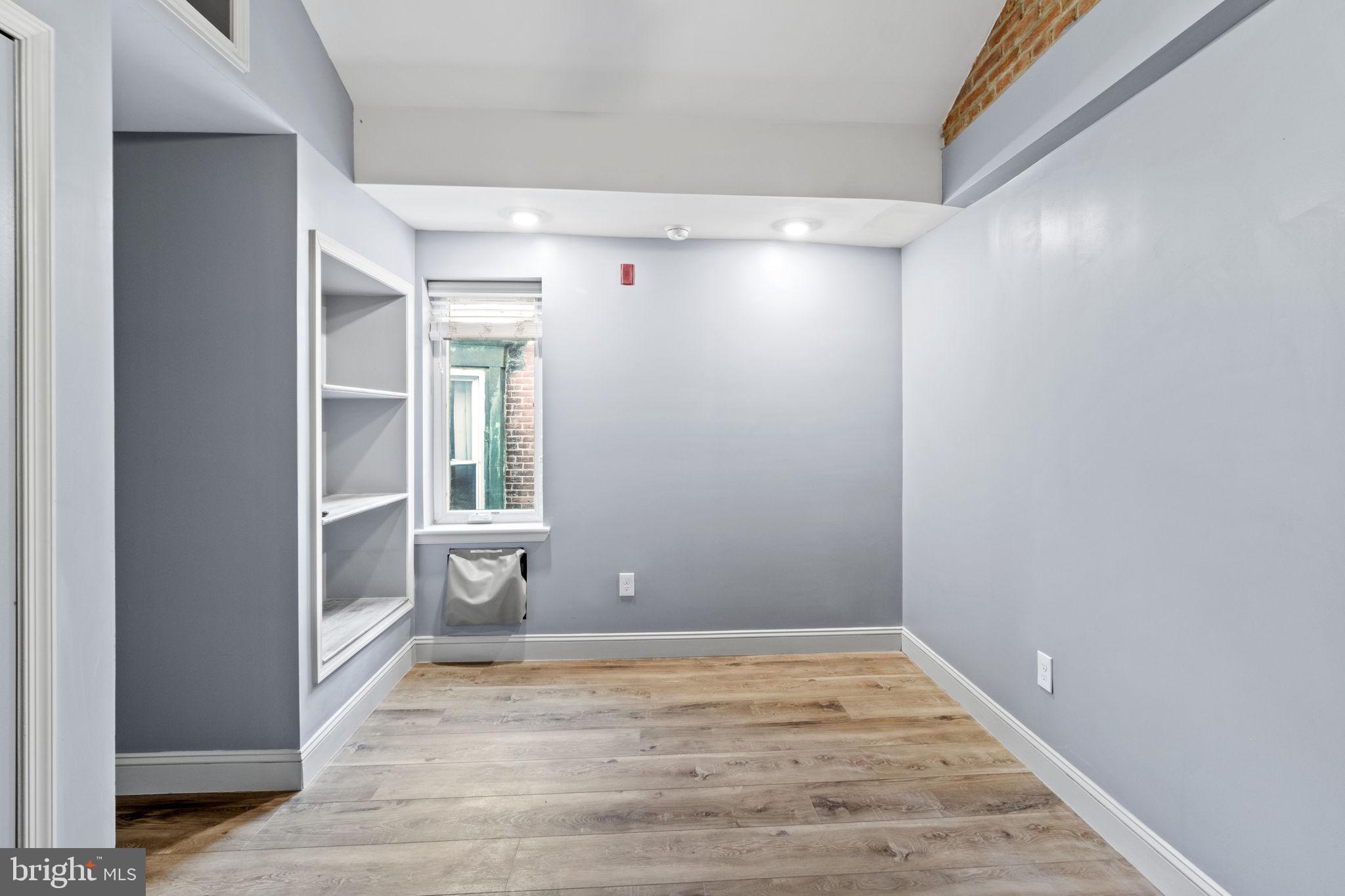 418 South 15th Street, Unit 2R Philadelphia, PA 19146 - Photo 22 of 26 a view of an empty room with wooden floor and a window