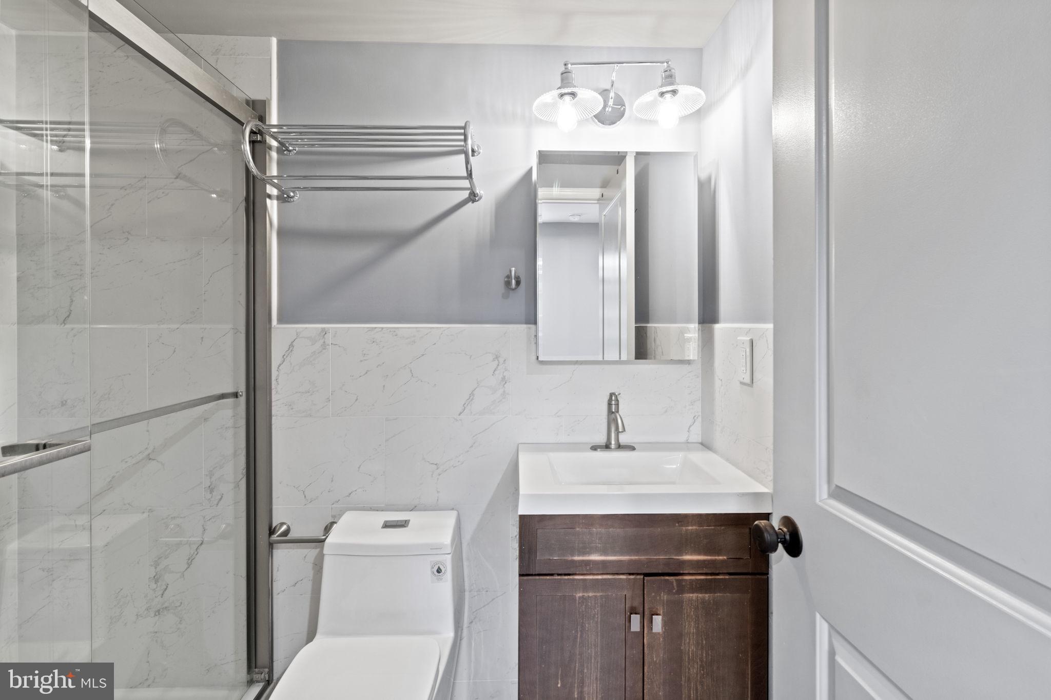 418 South 15th Street, Unit 2R Philadelphia, PA 19146 - Photo 23 of 26 a bathroom with a sink a toilet and shower