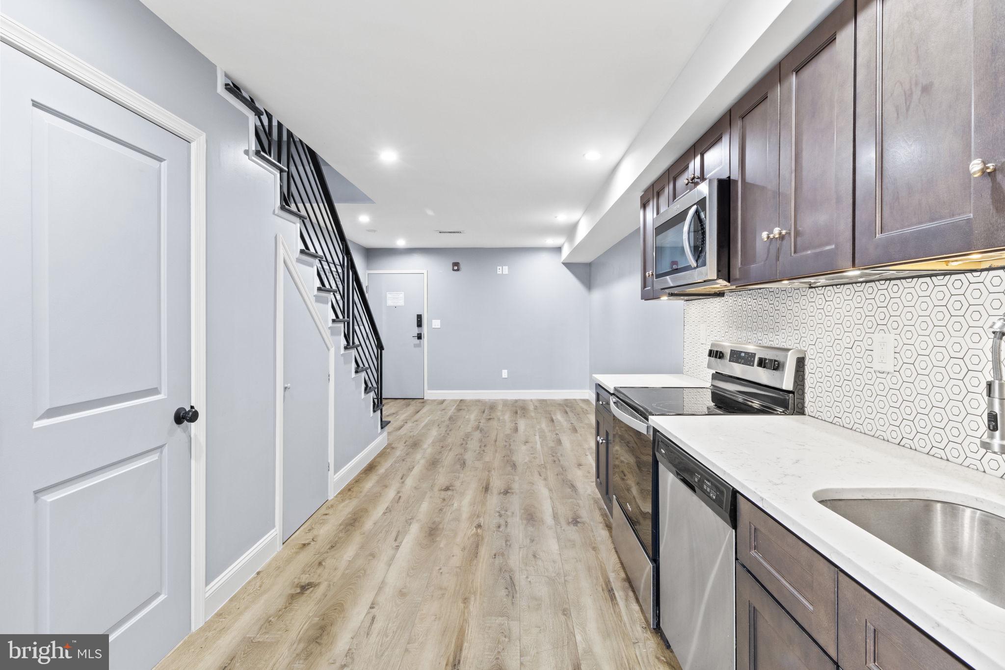 418 South 15th Street, Unit 2R Philadelphia, PA 19146 - Photo 10 of 26 a kitchen with a sink cabinets stainless steel appliances and a window