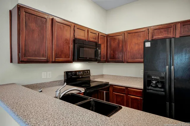 a kitchen with a refrigerator stove and cabinets