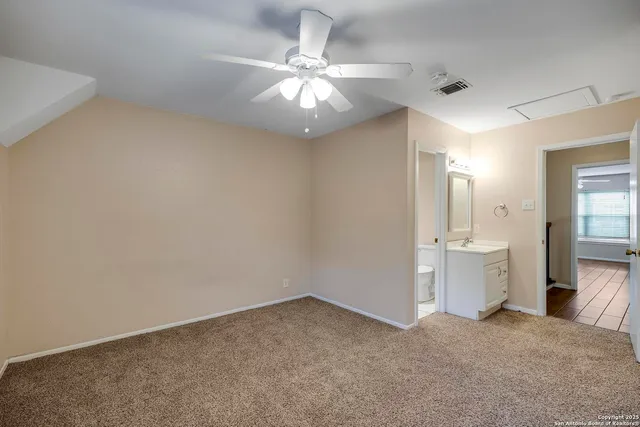 wooden floor in an empty room and a bathroom