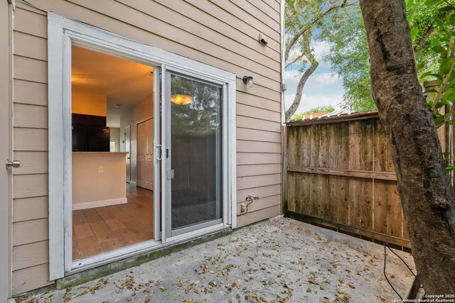 a view of a porch with a door and wooden bench