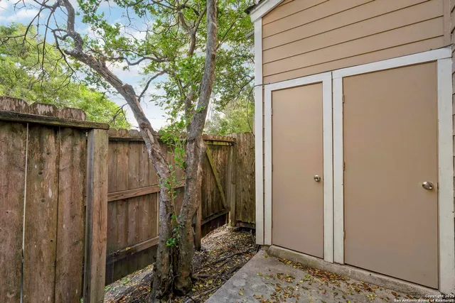 a view of a wooden door and a tree