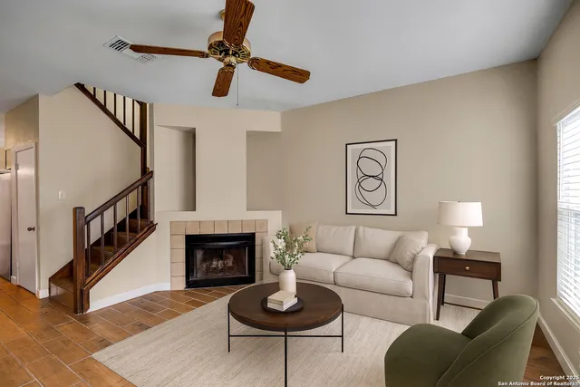 a living room with furniture a rug and a fireplace
