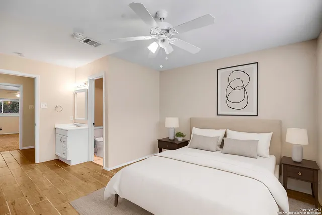 a bedroom with a large bed and a chandelier