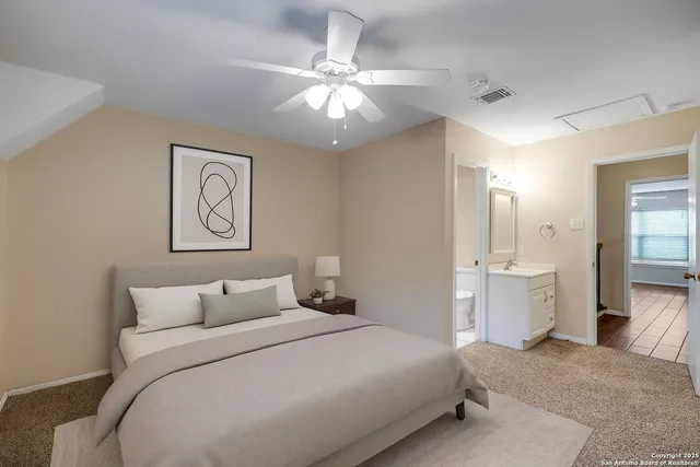 a bedroom with a large bed and a chandelier