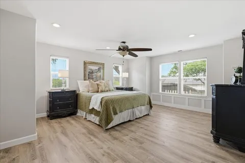 a bedroom with a bed and a large mirror