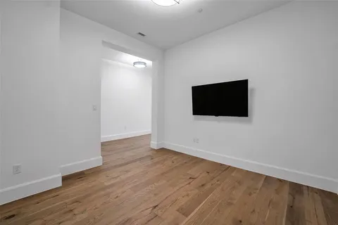an empty room with closet and windows