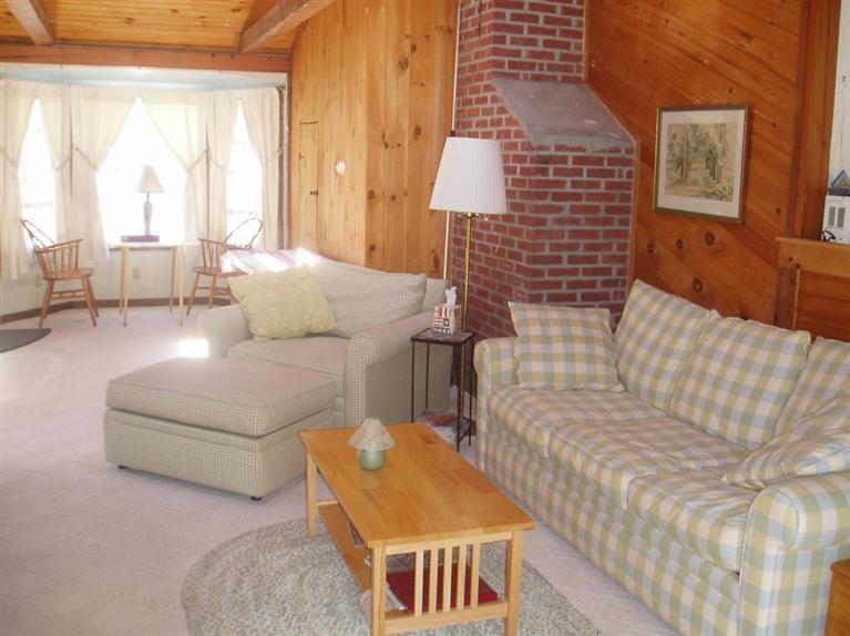 13 Shannon Road Harwich, MA 02645 - Photo 16 of 18 a living room with furniture and a large window