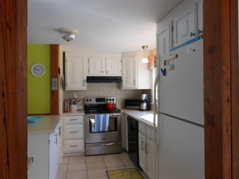 13 Shannon Road Harwich, MA 02645 - Photo 6 of 18 a kitchen with stainless steel appliances granite countertop a refrigerator sink stove and cabinets