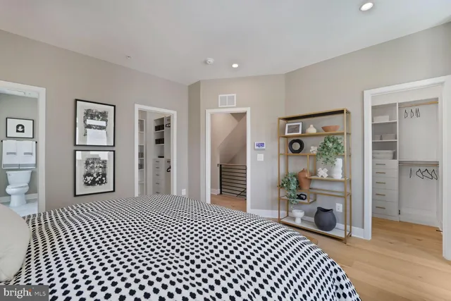 a bedroom with a large bed and a chandelier