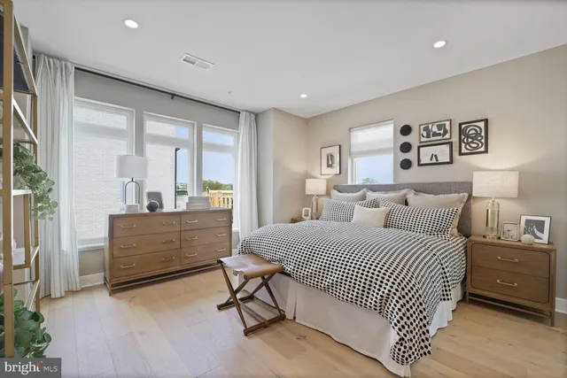 a bedroom with a bed and a large window