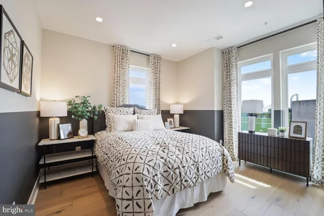 a bedroom with a large bed and a large mirror