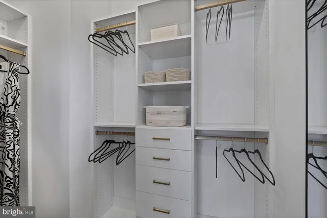 a view of a hallway and a livingroom with furniture