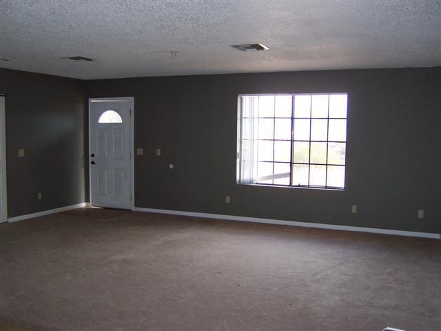 884 Elote Court, Unit CORTE Rio Rico, AZ 85648 - Photo 2 of 13 an empty room with glass door and windows