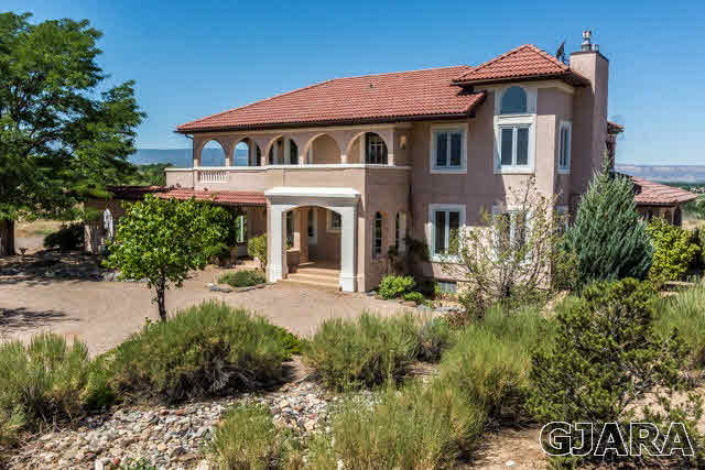 3412 D Road Palisade, CO 81526 - Photo 1 of 9 a front view of a house with a garden