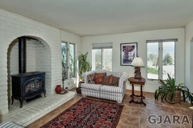 3412 D Road Palisade, CO 81526 - Photo 5 of 9 a living room with furniture and a fireplace