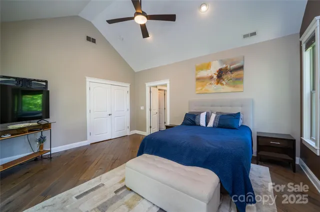 a bedroom with a bed and a flat screen tv