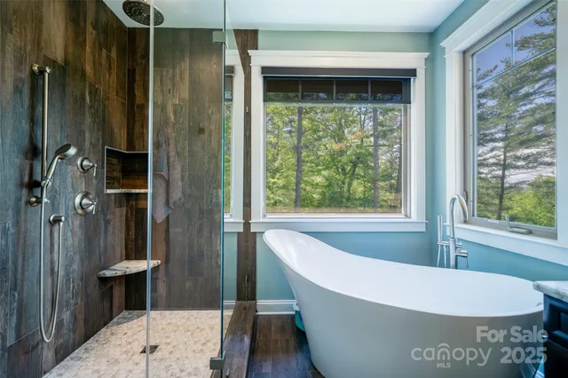 a living room with a large window and wooden floor