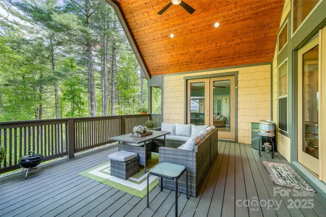 a spacious bedroom with a large window and furniture