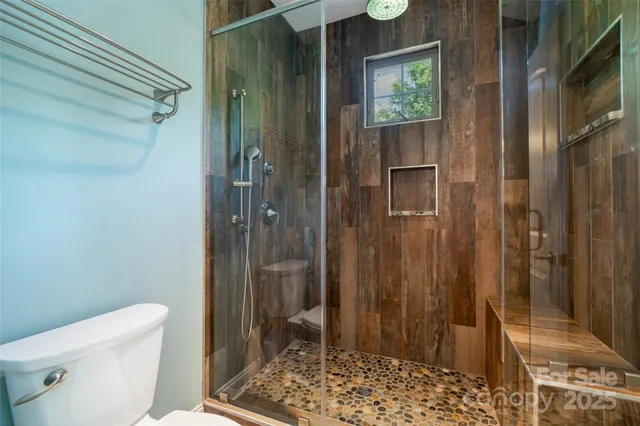 a bathroom with a granite countertop sink toilet bathtub and shower