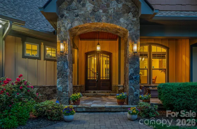 a living room with furniture a dining table and a chandelier